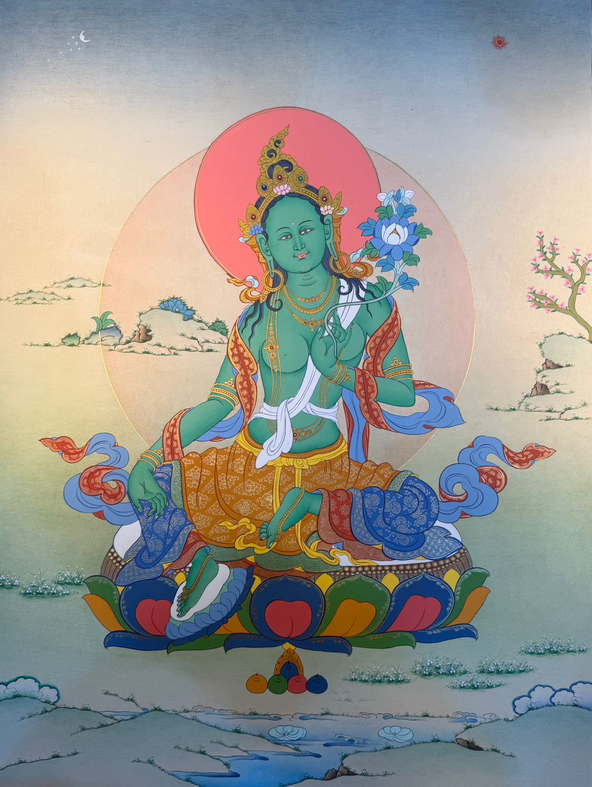 Thangka painting of Green Tara seated with halo and blue lotus, colorful robes.