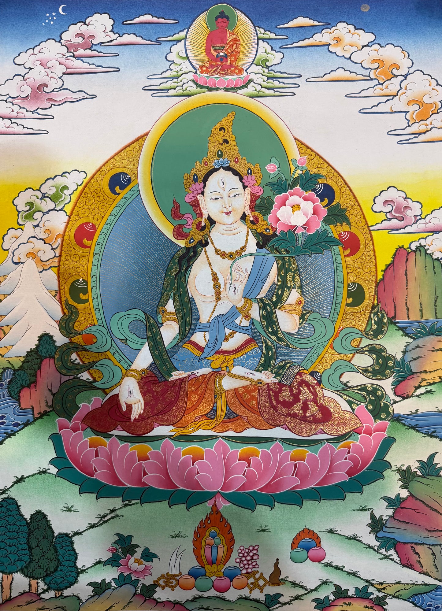 Tara thangka painting of goddess seated in lotus pose with ornate halo and robes