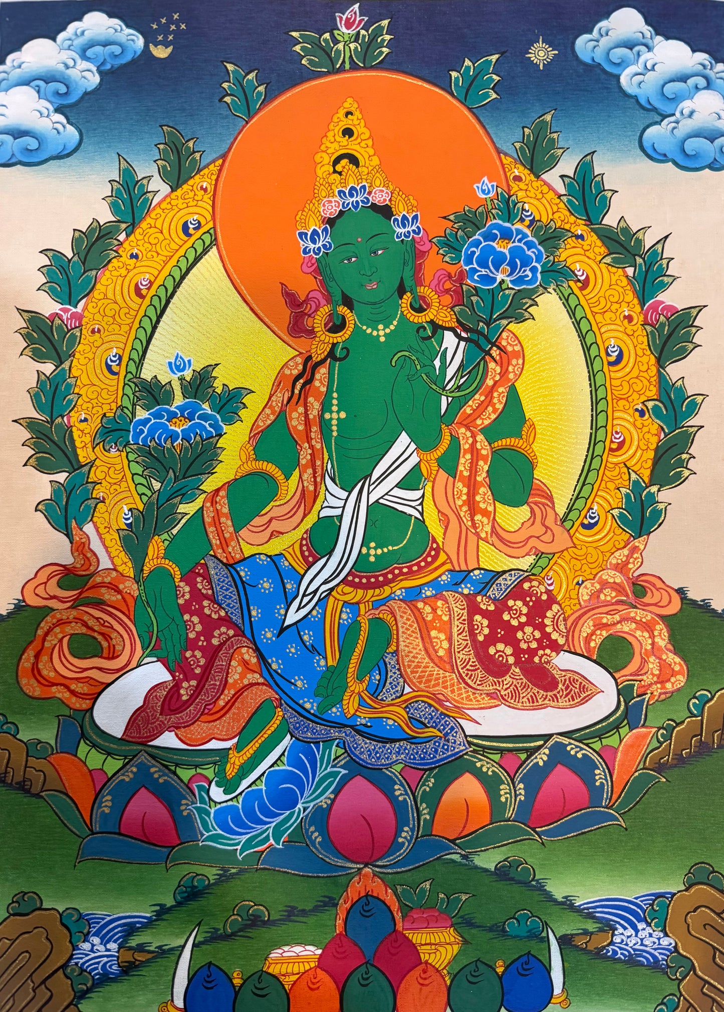 Green Tara thangka painting with green goddess seated on lotus, orange halo and floral details