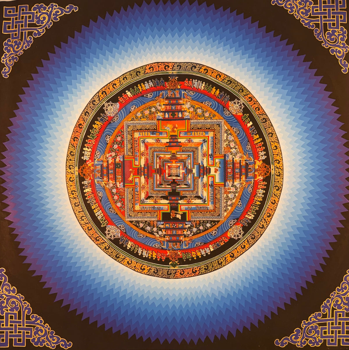 Kalachakra mandala thangka painting with an intricate orange, blue, and gold circular design
