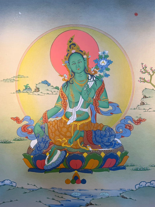Thangka painting of Green Tara seated on a lotus with blue and orange robes