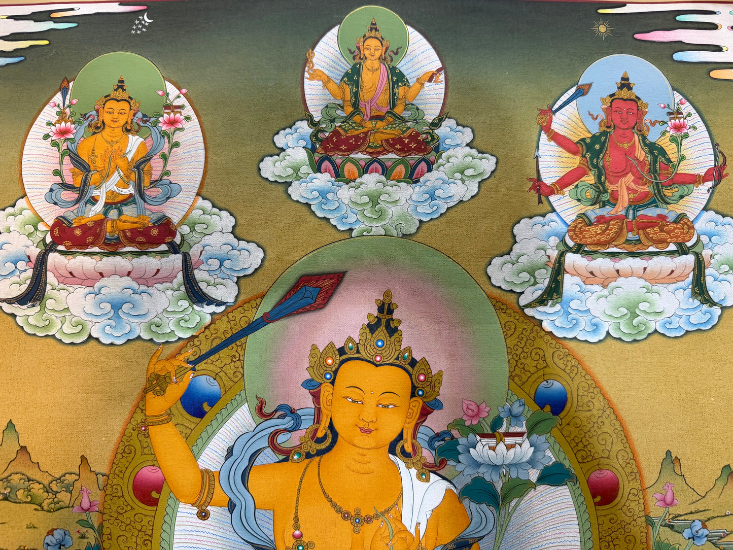 Thangka painting close-up of gold-faced deity seated on lotus with blue and green halo