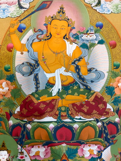 Thangka painting close-up of smiling gold-faced deity holding lotus, ornate robes and jewelry