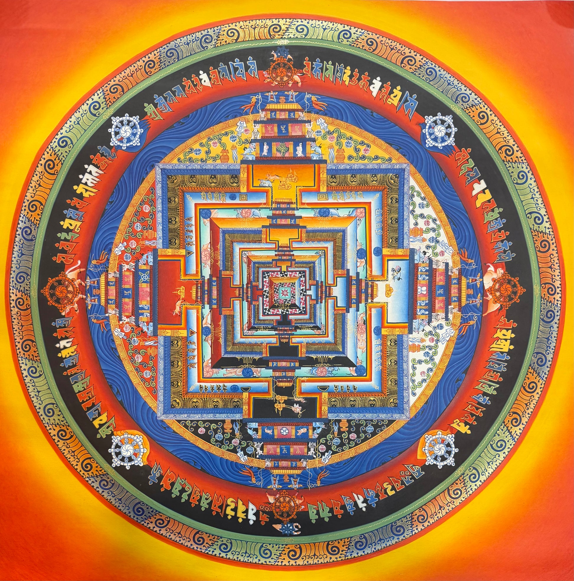 Kalachakra mandala thangka painting with concentric geometric circle in blue, gold, and red