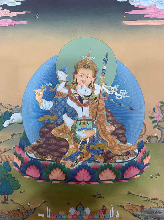 Framed thangka painting of seated Guru Rinpoche with halo, ornate robes, lotus flowers