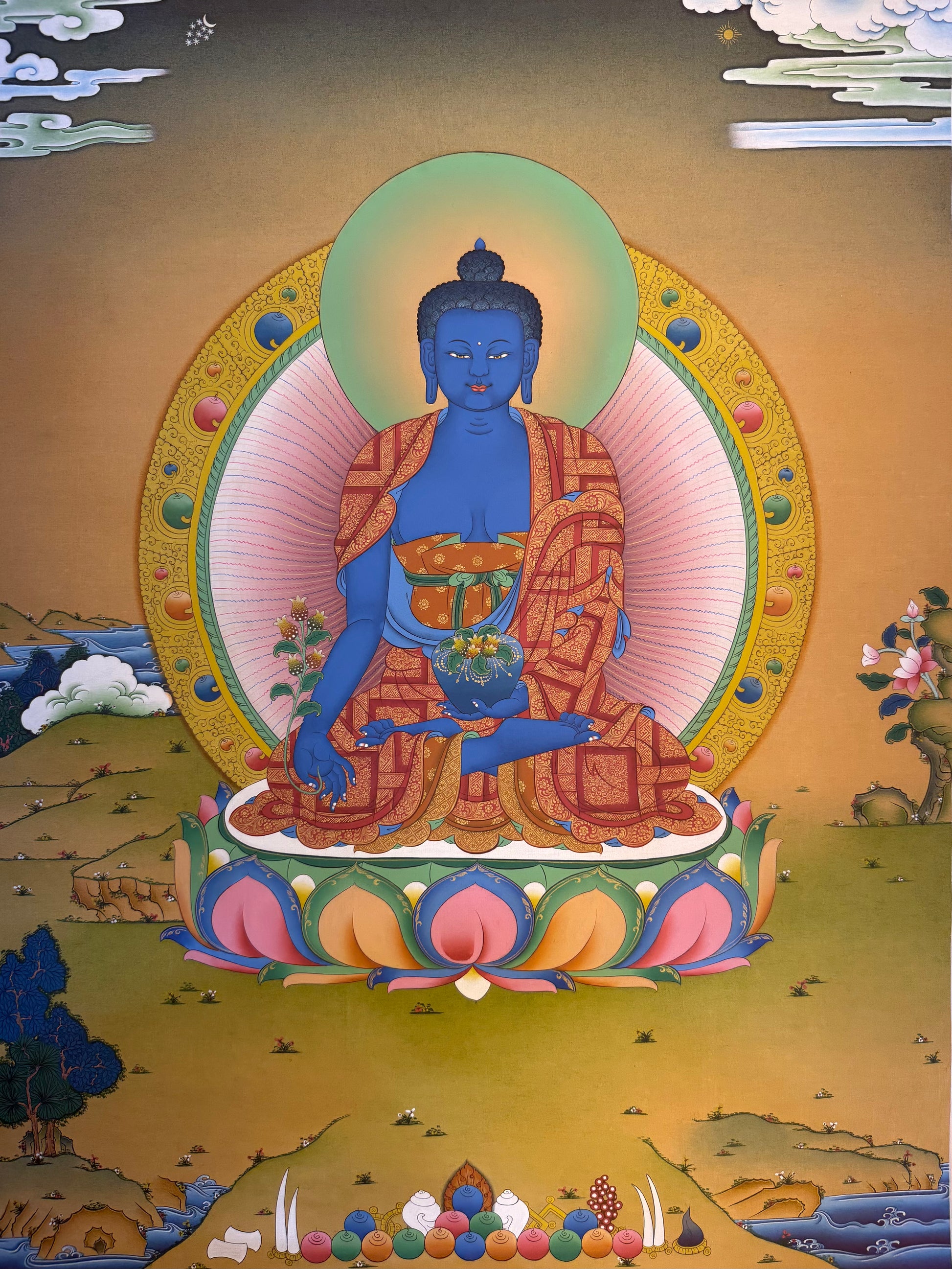 Medicine Buddha thangka painting with blue seated Buddha, ornate robes and gold halo